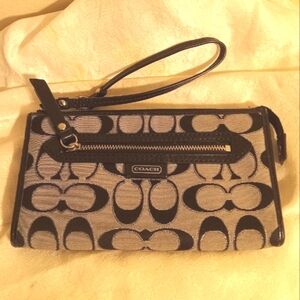 Coach canvas gray and black zip around wallet and wristlet.